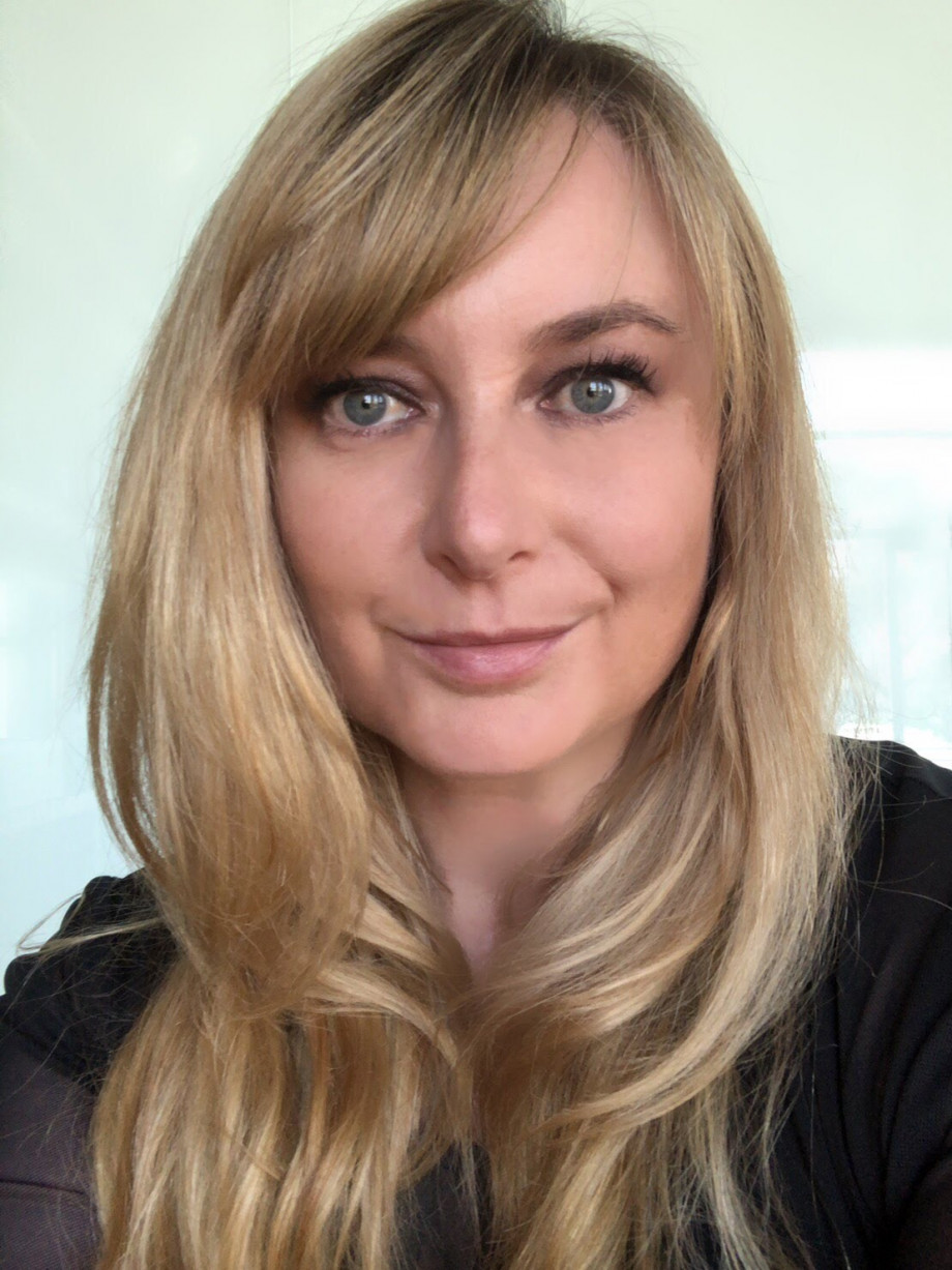 A woman with blond hair smiling at the camera.