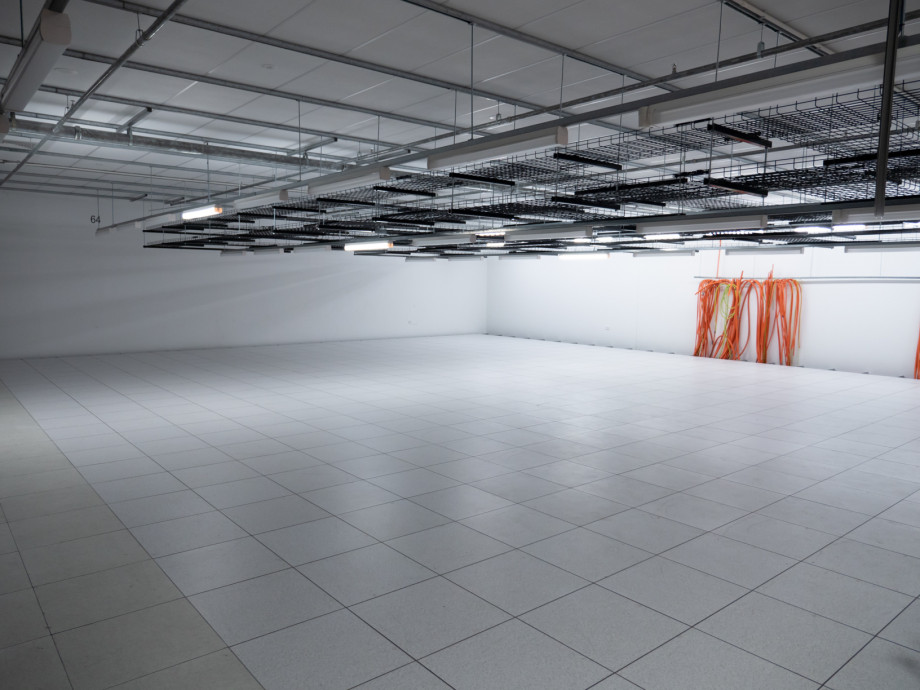 An empty space in a data centre with brand new flooring.