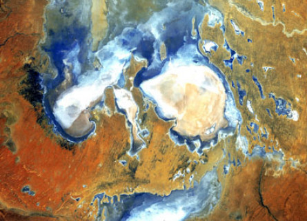 Lake Eyre Kathi-Thanda viewed from space, several blue and white lakes surrounded by red desert.