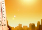 Thermometer in front of city.