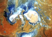 Lake Eyre Kathi-Thanda viewed from space, several blue and white lakes surrounded by red desert.
