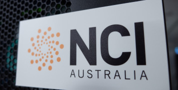 NCI logo on a black cabinet, with some flashing lights showing through behind it.